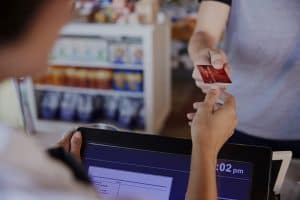 Cashier Accepts Card Payment From Customer In quick serve restaurant